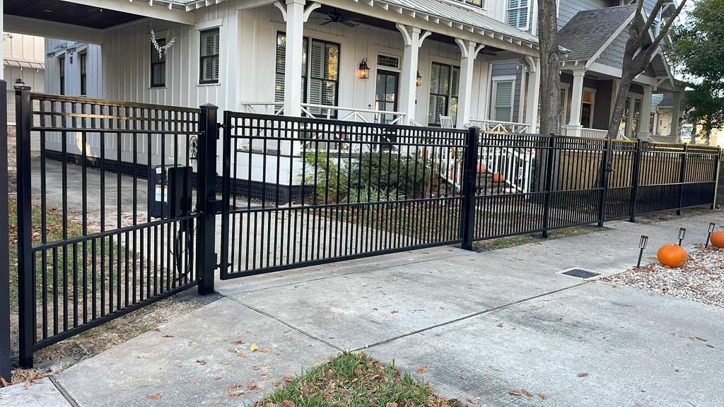 Completed black metal front fence and custom pedestrian gates