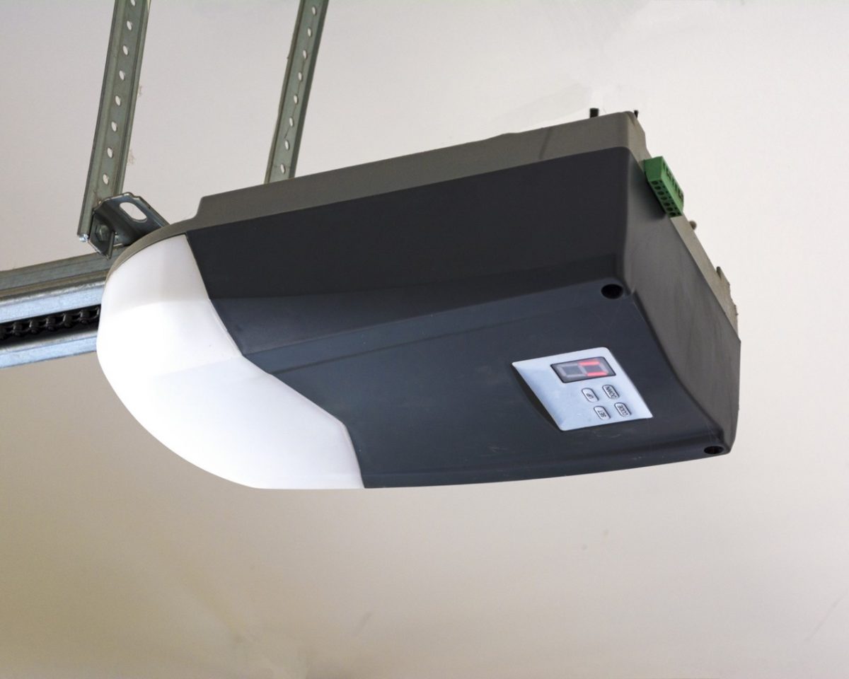 Garage door opener mounted above a residential garage door