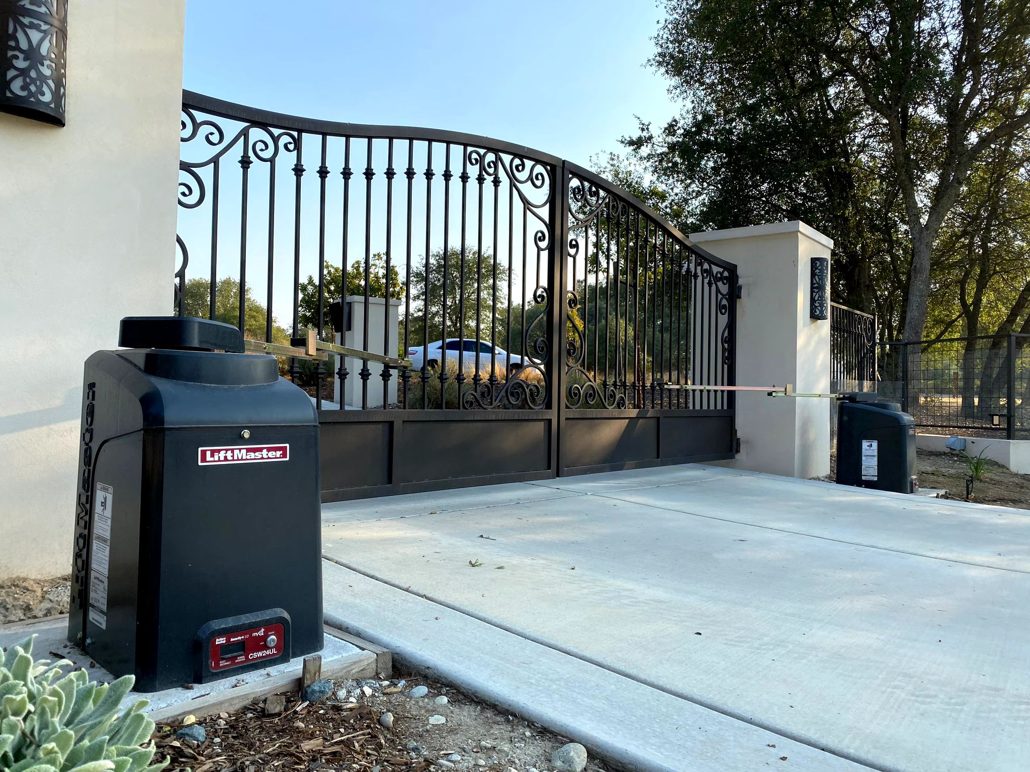 LiftMaster automatic gate operator installed beside a driveway gate