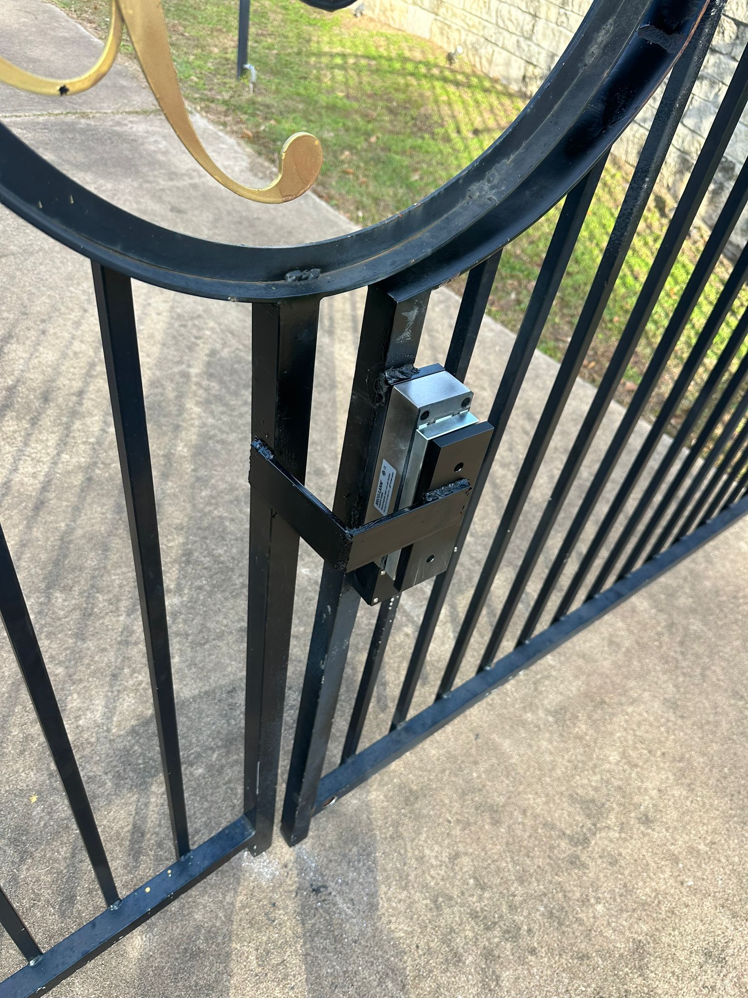 Magnetic lock installed on a metal pedestrian gate