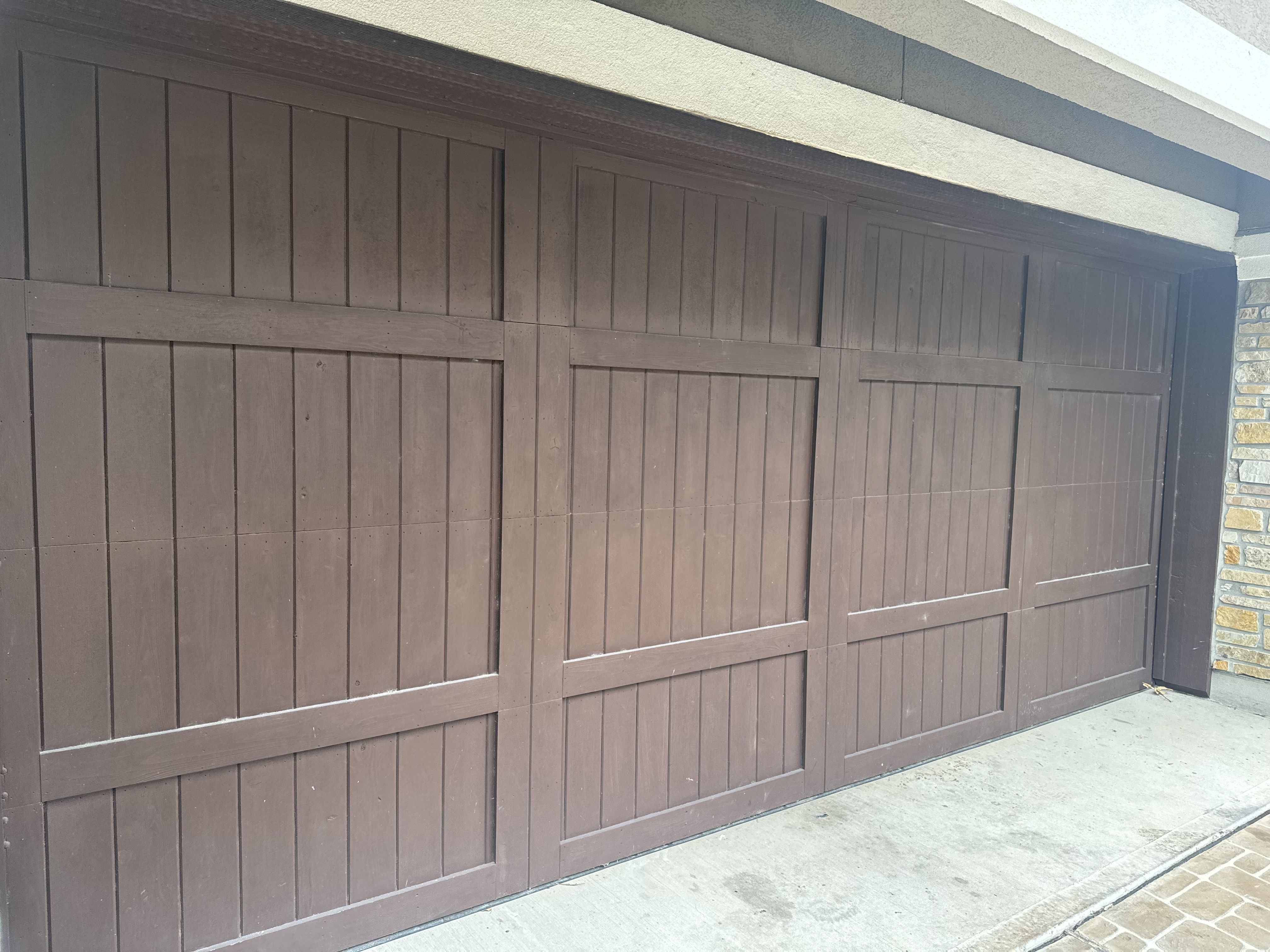 Premium wood-look garage door installed on a home