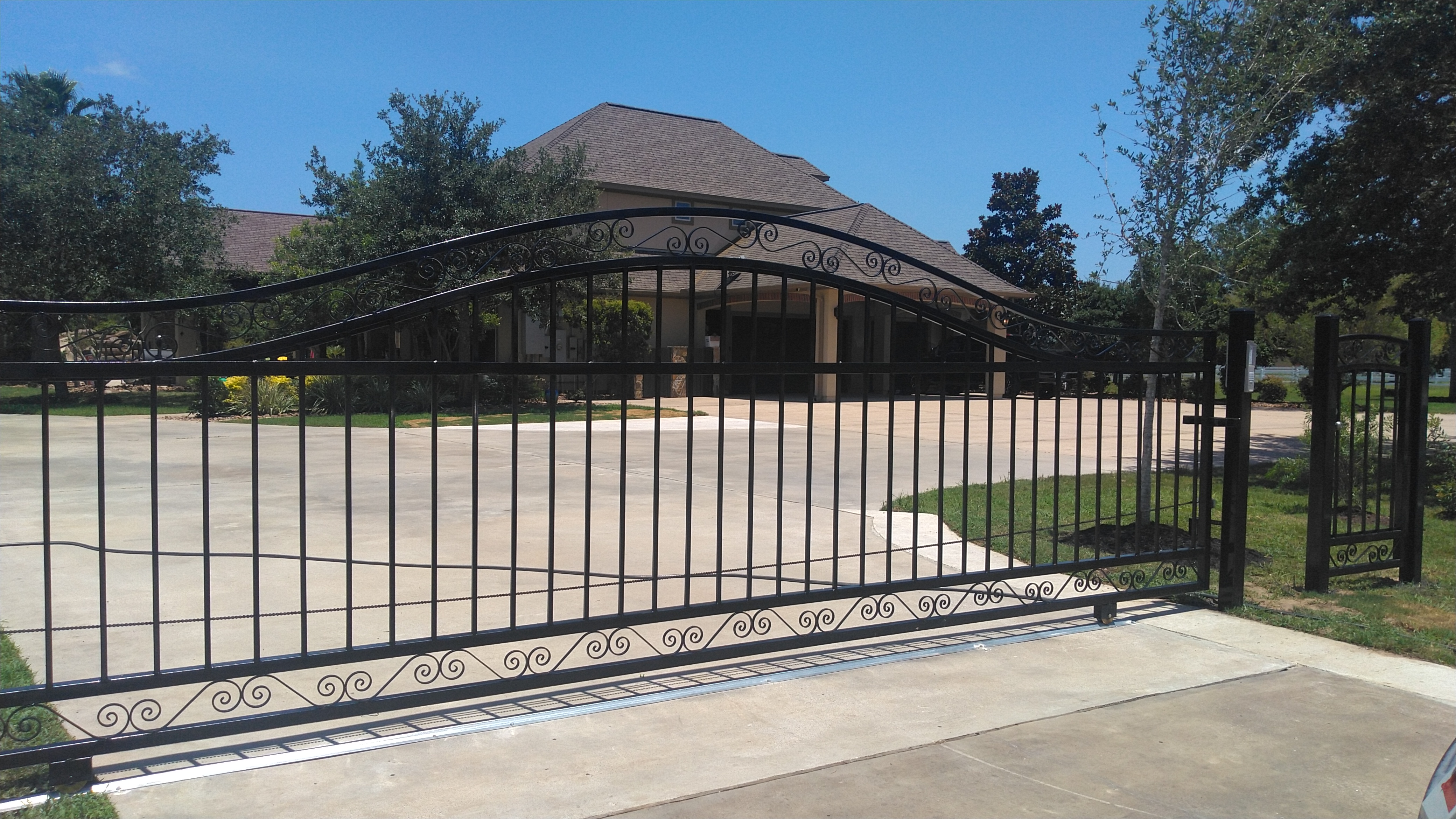 Decorative sliding driveway gate at a residence